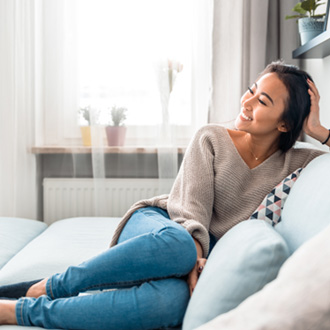 Woman smiling while relaxing at home