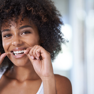 Woman smiling while flossing