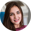 Teenage girl with braces smiling in dental chair
