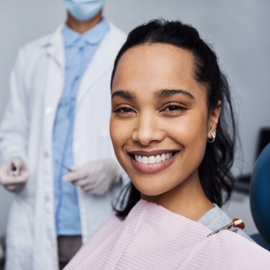 Smiling woman sitting in treatment chair at Wayland orthodontic office