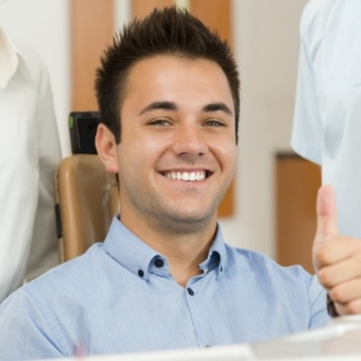 Smiling man in orthodontic treatment chair