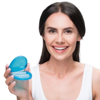 Woman holding carrying case for her Invisalign aligners