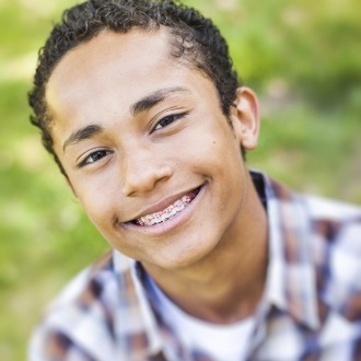 Teen boy with braces smiling