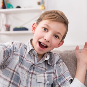 Smiling young boy sitting on couch