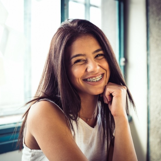 Young woman grinning with braces