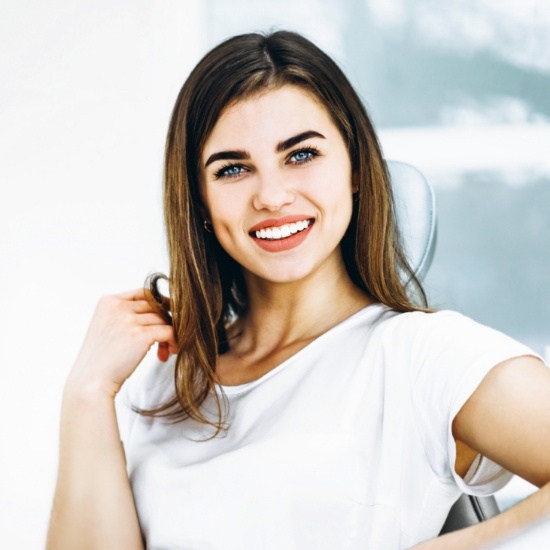 Smiling woman in orthodontic treatment chair
