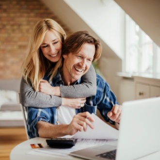 Man and woman looking at laptop together